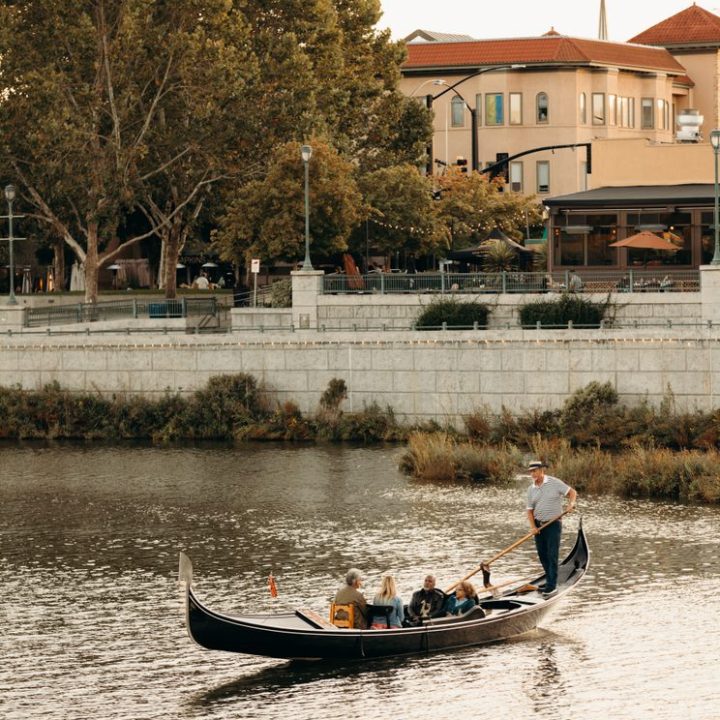 a group of people in a small boat in a body of water