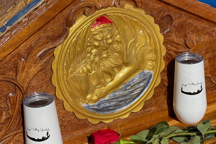 a bottle next to a cup of coffee on a table