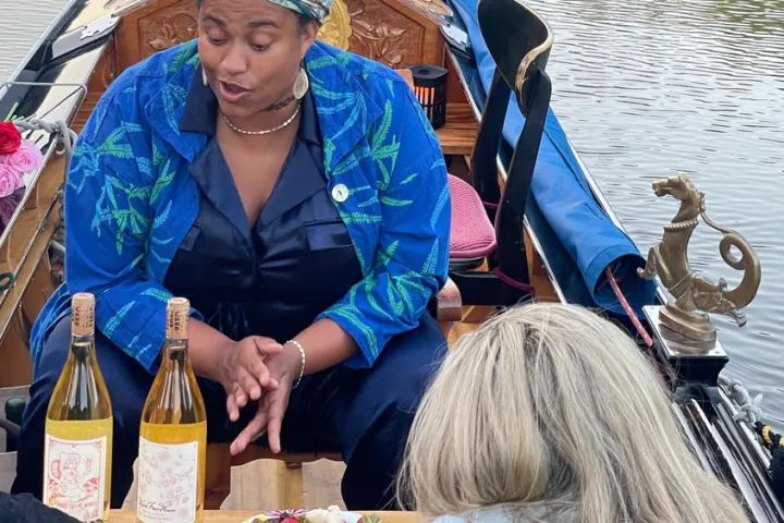 a woman sitting next to a bottle of water