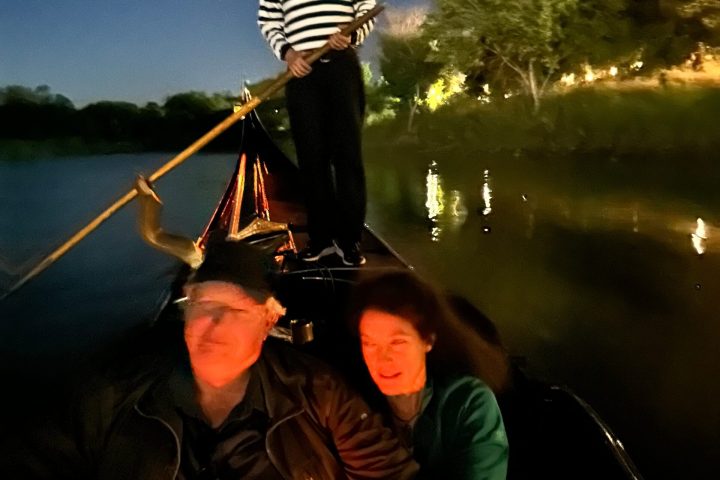a group of people in a boat on a body of water